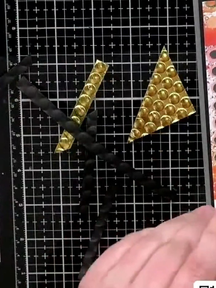 Step 4: Glue the gold embellished strips down onto your card, overlapping them to create depth and dimension. Ensure t