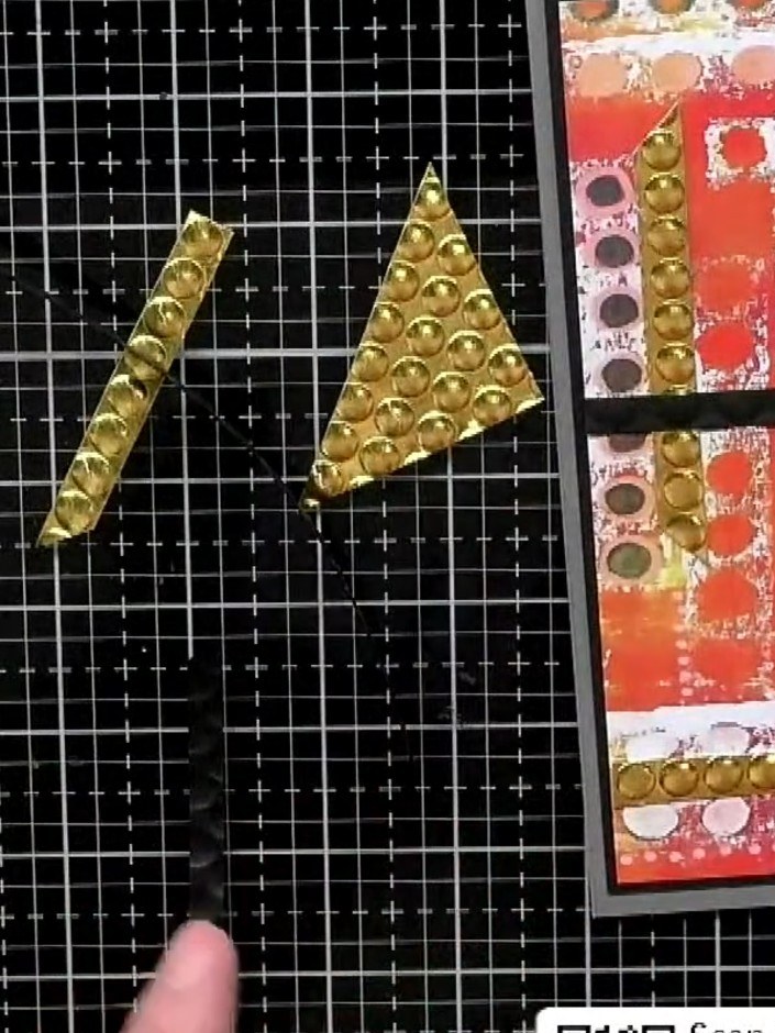 Step 5: Add additional gold embellishment strips in contrasting directions to create visual interest. Cut some strips 