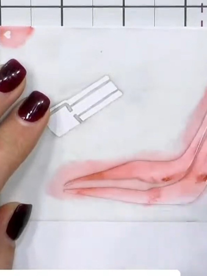 Step 2: Apply red ink through the first stencil layer using a sponge applicator, pressing firmly to transfer the colou