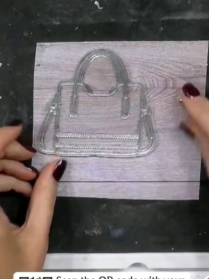 Step 3: Stamp the handbag design onto the patterned paper using the clear acrylic stamp, pressing firmly and evenly to