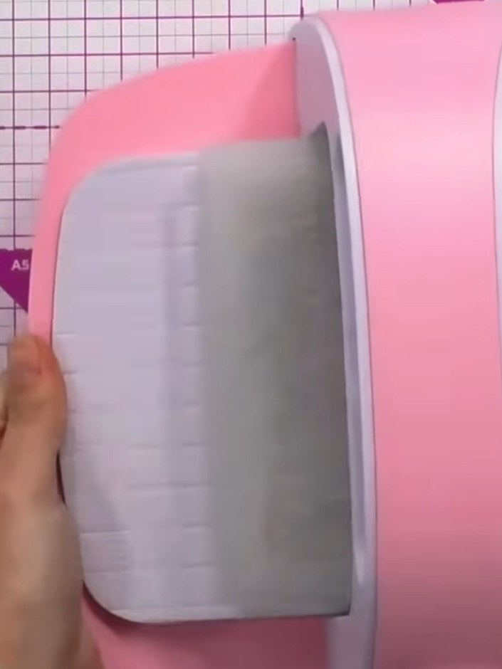 Step 4: Place your white card stock into the inked embossing folder and run it through your die-cutting machine three 