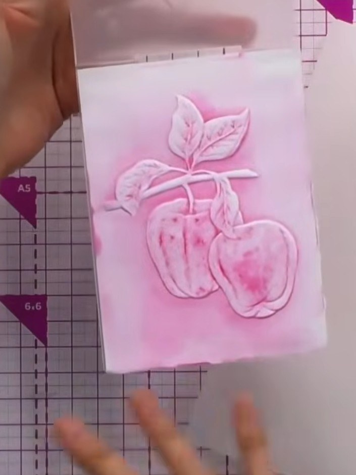 Step 5: Remove the card from the embossing folder and allow it to dry completely. Observe the abstract, watercolour-li