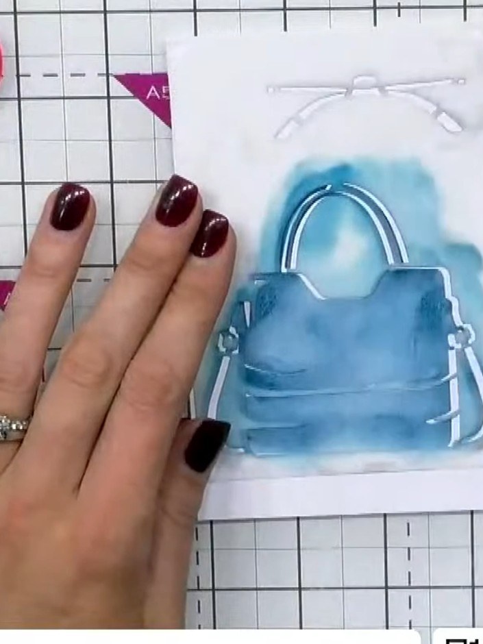 Step 4: Place stencil three over the handbag and apply blue ink, pressing firmly to create darker definition on this f