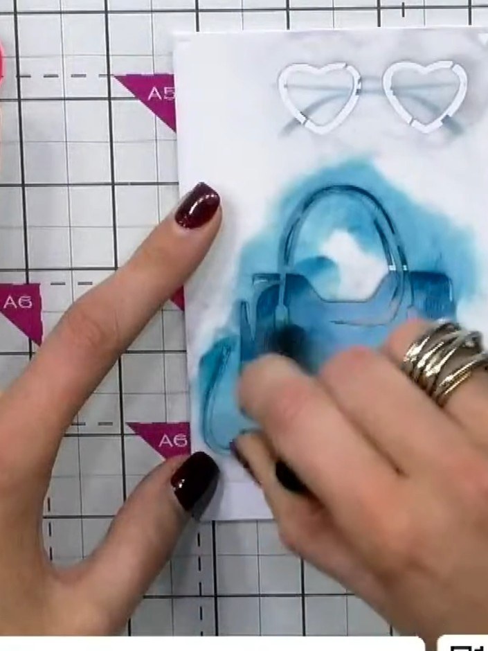 Step 5: Position the sunglasses stencil at the top of the card. Apply blue ink through the stencil using a blending to