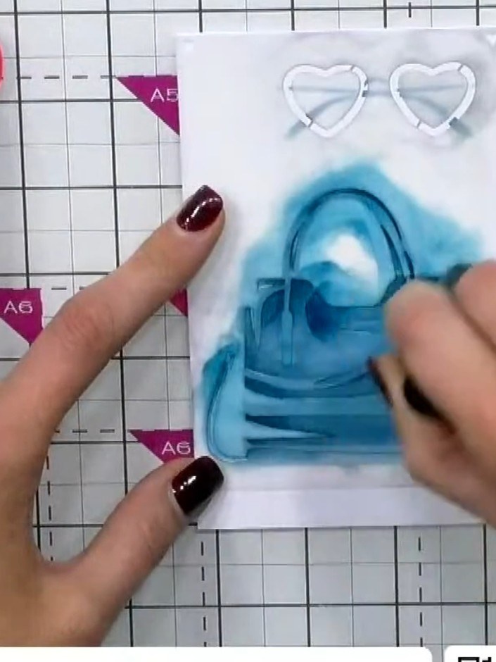 Step 6: Apply the second stencil layer to build up the sunglasses design on the card. Continue adding layers with the 
