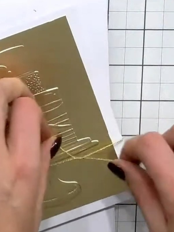 Step 10: Add a sentiment from the included word set to complete your card. Position the sentiment on the gold embossed 