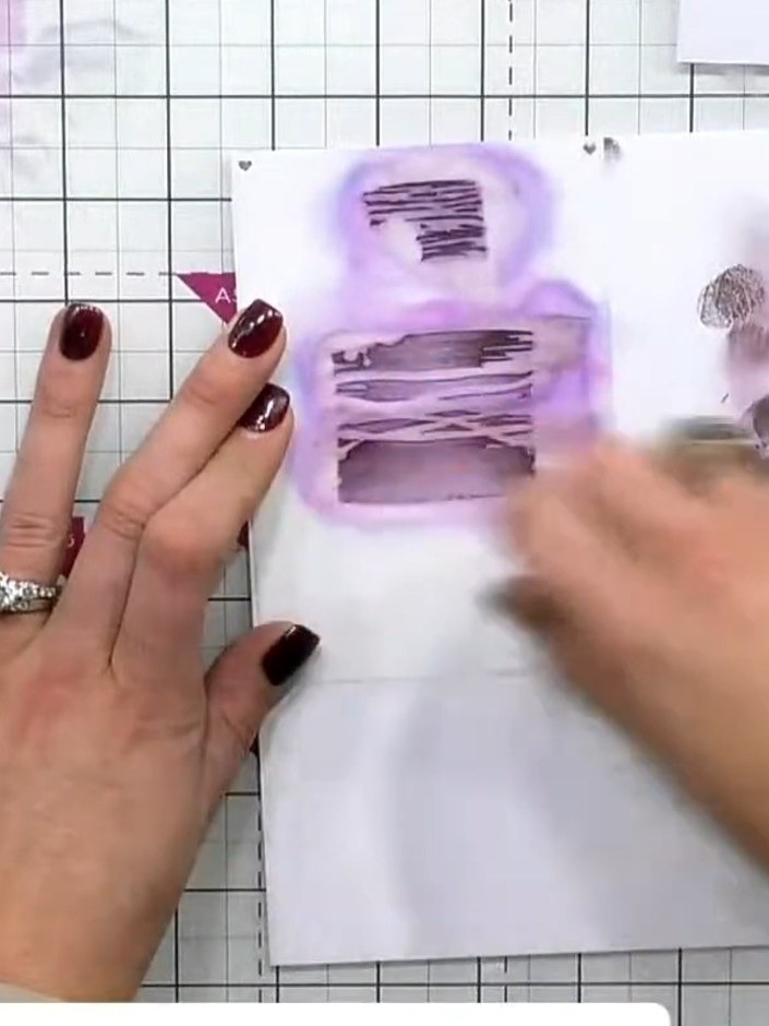 Step 4: Using a slightly darker purple ink pad, press through the second stencil onto the card. Apply firmer pressure 