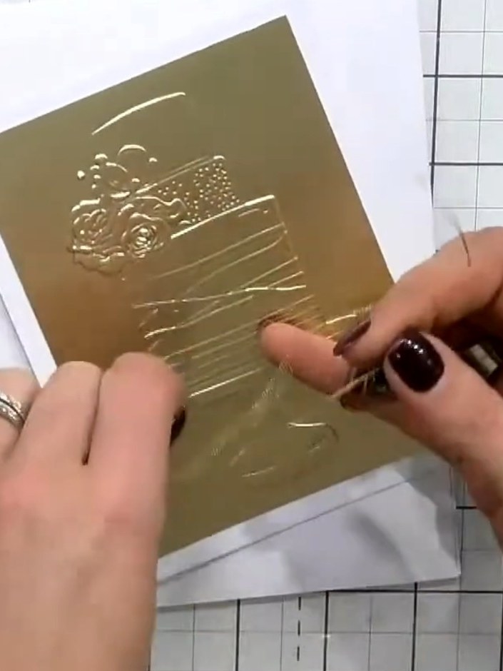 Step 9: Attach the gold embossed cake piece to your white card base using foam pads to add dimension and lift it off t