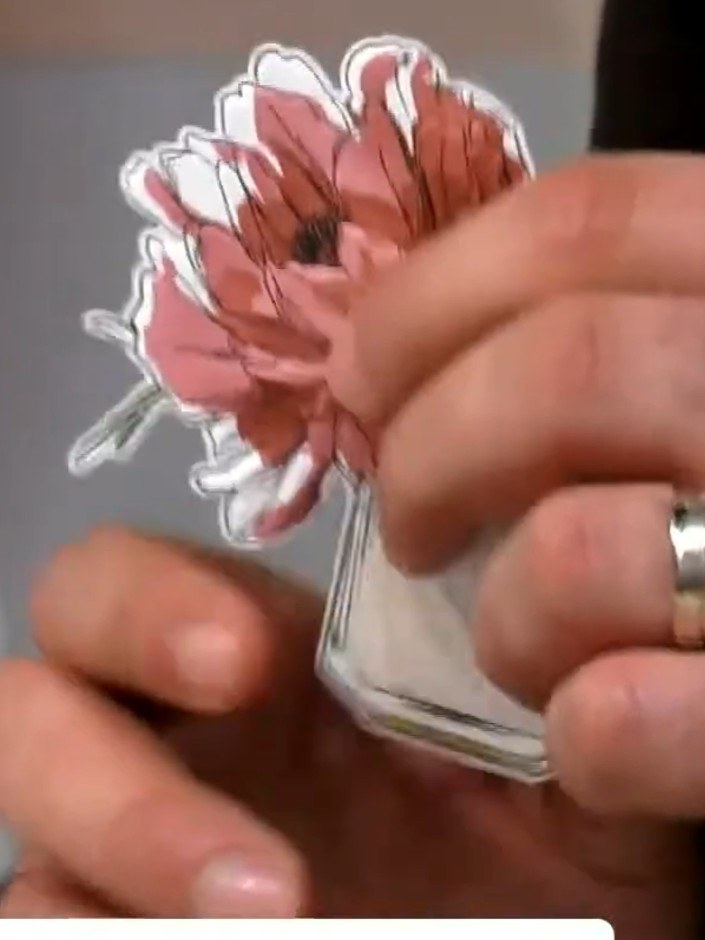 Step 8: Mount the embossed floral piece onto your card base. For added dimension, use foam pads to attach the piece, c