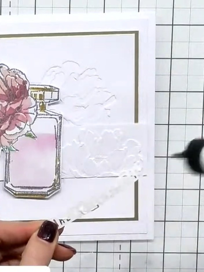 Step 4: Mount the embossed perfume bottle piece onto an olive green card base. Position the 'LIVE A LIFE OF LOVE' sent