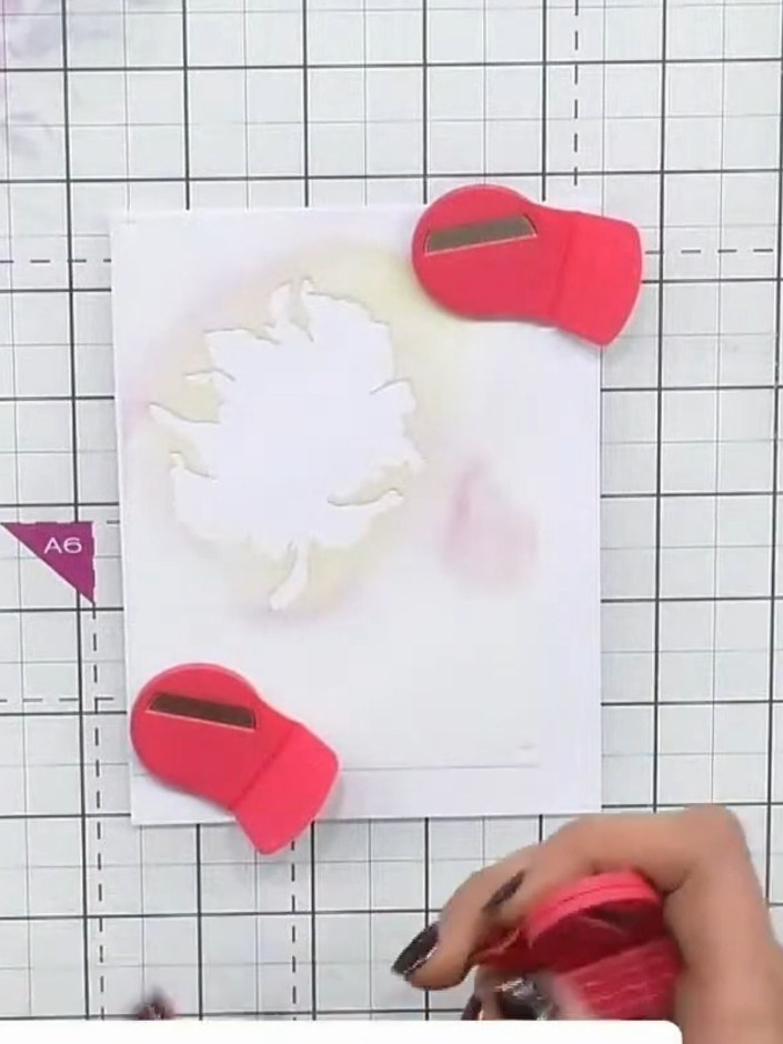 Step 1: Place stencil number one on white cardstock and position it in the corner. Use the magnetic mat and pink magne