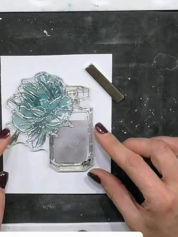 Step 7: Stamp the perfume bottle outline stamp onto the inked design, carefully lining it up with the stencilled turqu