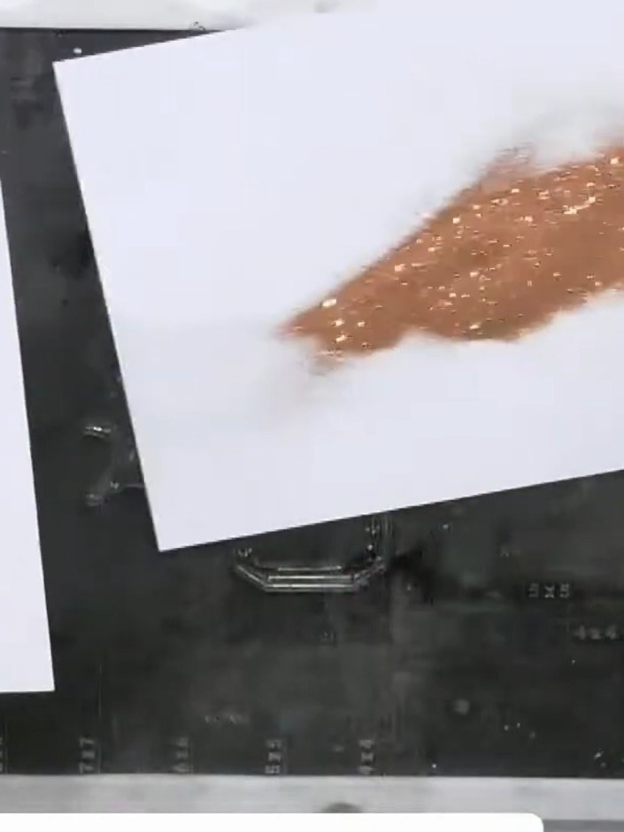 Step 8: Sprinkle copper embossing powder over the stamped perfume bottle outline. Tap off the excess powder and heat-s