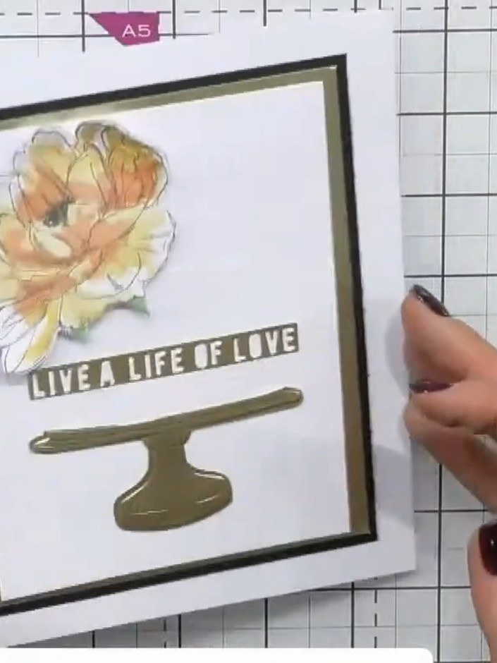 Step 10: Add a sentiment strip across the card. Position it below the flower and above the cake stand element. The exam