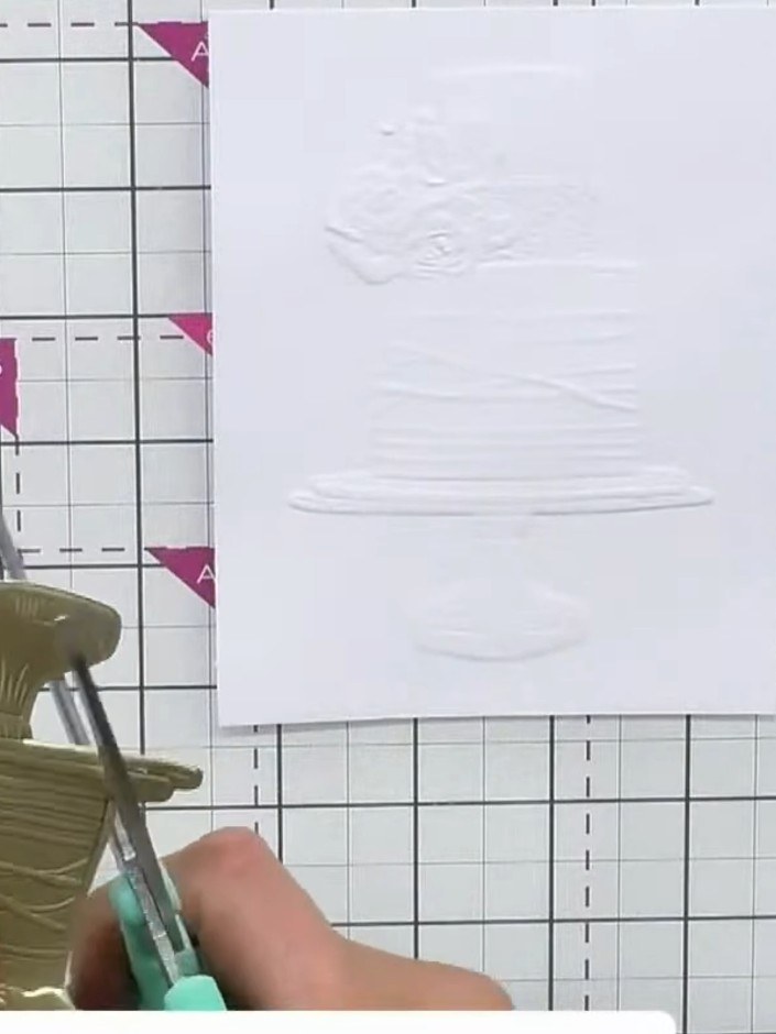 Step 5: Cut away the pedestal section from the white die-cut cake using scissors. This will allow you to replace it wi