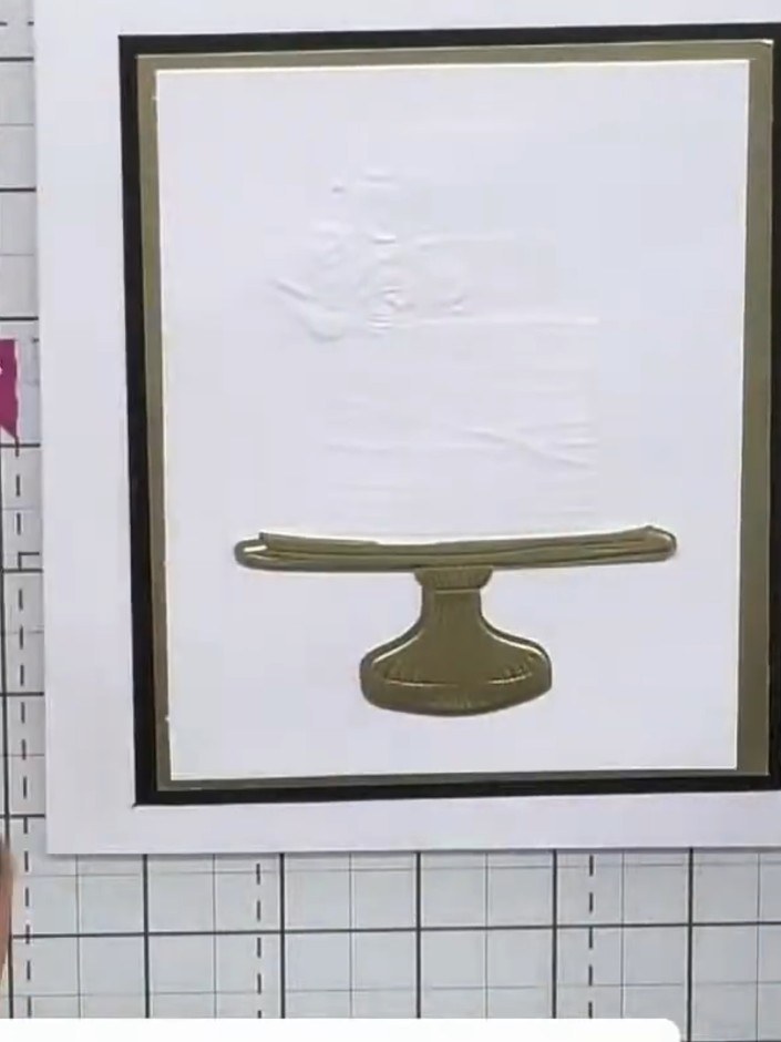 Step 9: Adhere the raised embossed flower piece on top of the cake stand design to complete your card. Position it cen