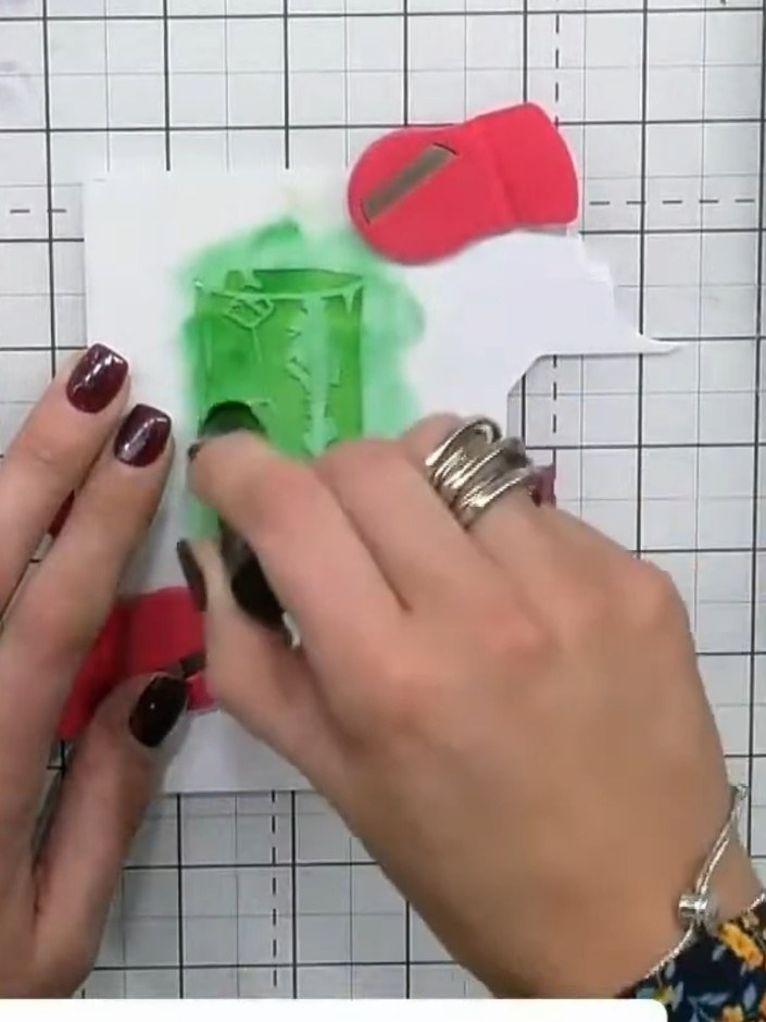 Step 2: Apply light green ink through the first stencil using a sponge applicator, working from the corner of the whit