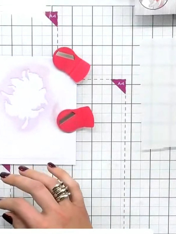 Step 1: Position stencil number one on your card base, aligning it to the edge. Use the corner hearts on the stencil a