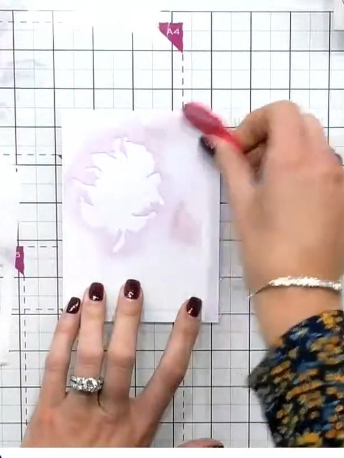 Step 2: Apply yellow and orange ink through the first stencil layer to create the base floral design on your card. Hol