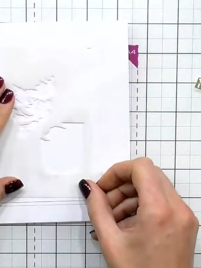 Step 1: Run a piece of white card through the 3D embossing folder to create the dimensional perfume bottle design. Thi