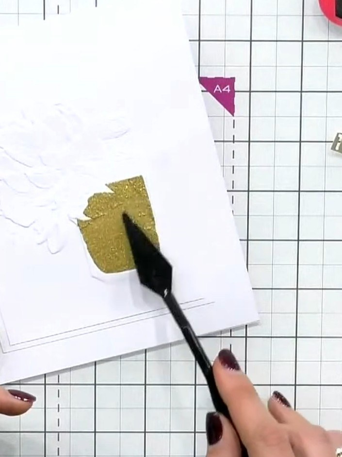 Step 4: Apply gold glitter paste through the stencil onto the perfume bottle using a spatula. Work carefully to fill i