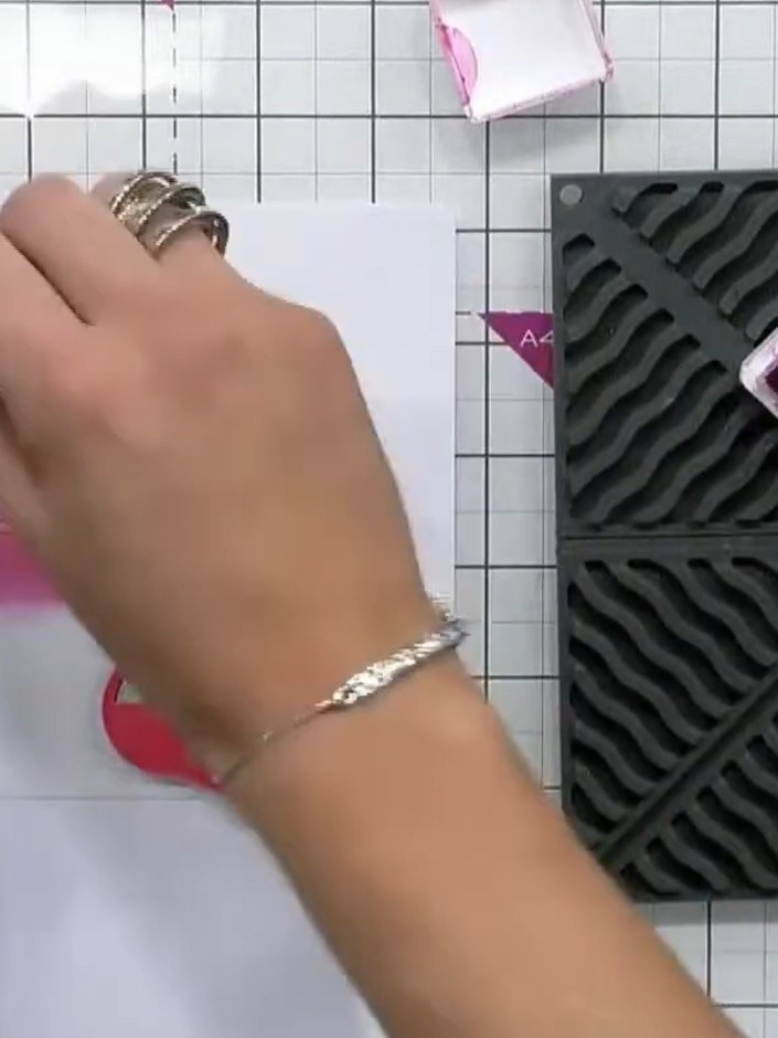 Step 4: Apply a darker shade of pink ink through the second stencil to add dimension and shading to the cake layers. U