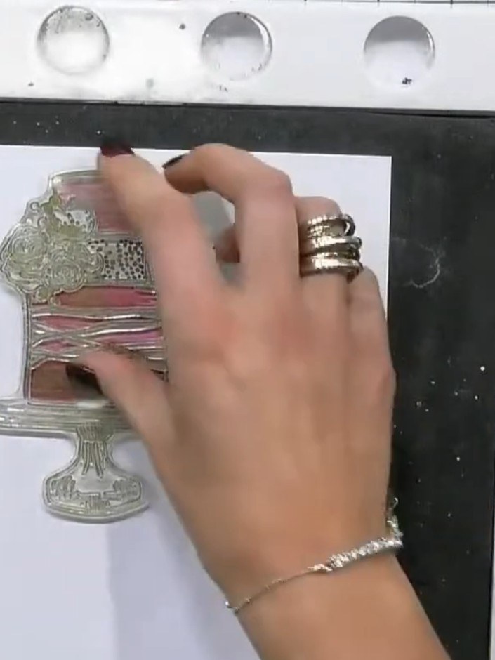 Step 9: Run the embossing folder with the cake design through your die-cutting machine to create the three-dimensional