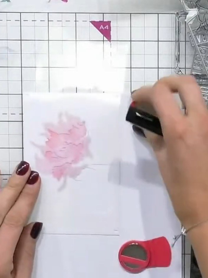 Step 3: Position stencil two over your work. Using the pink ink pad and blending tool, apply colour through the stenci