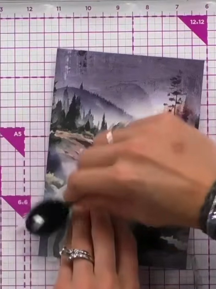 Step 2: Using a blending brush, dab white ink from an ink pad around the edges of the wolf mask to create a halo or sh