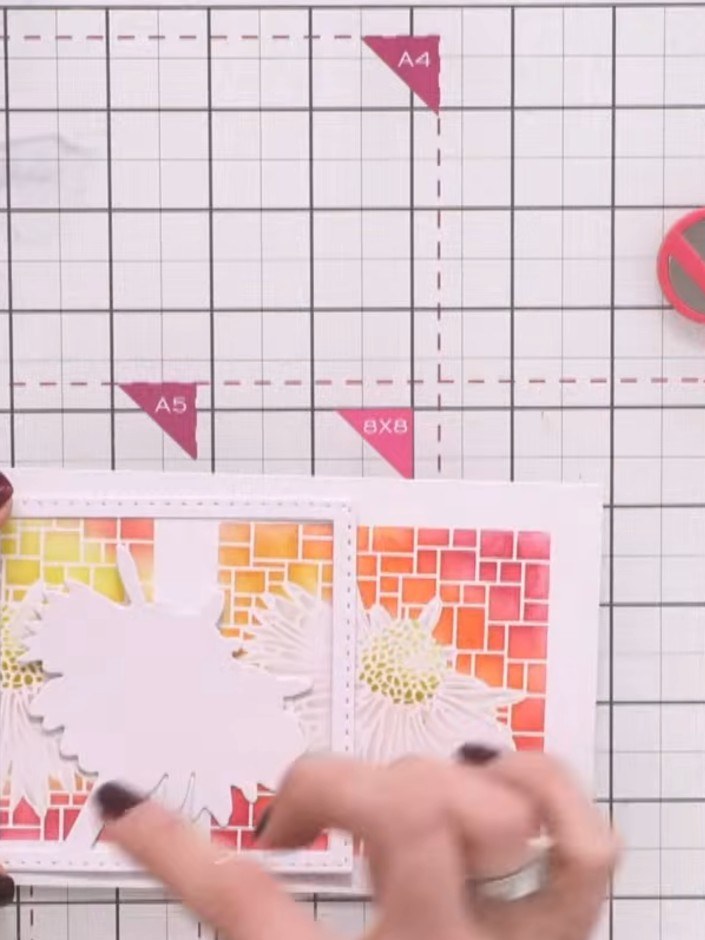 Step 9: Place the coordinating die-cut daisy stamp on top of your stencilled panel. Stamp in black ink to add detail a