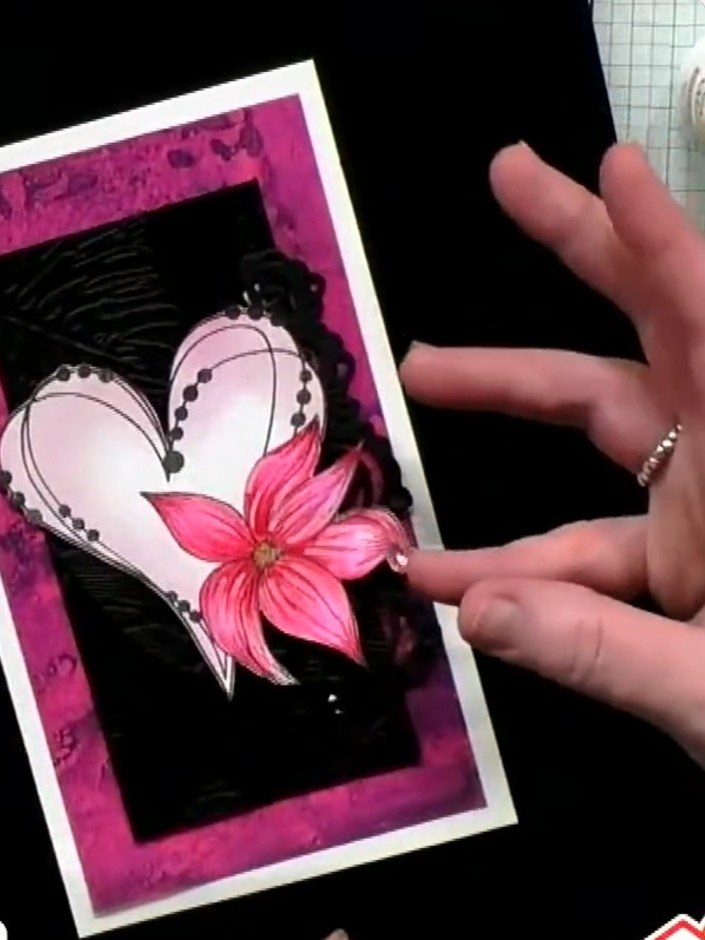 Step 4: Colour the pink flower element on the card using a suitable colouring medium. Work carefully to add depth and 