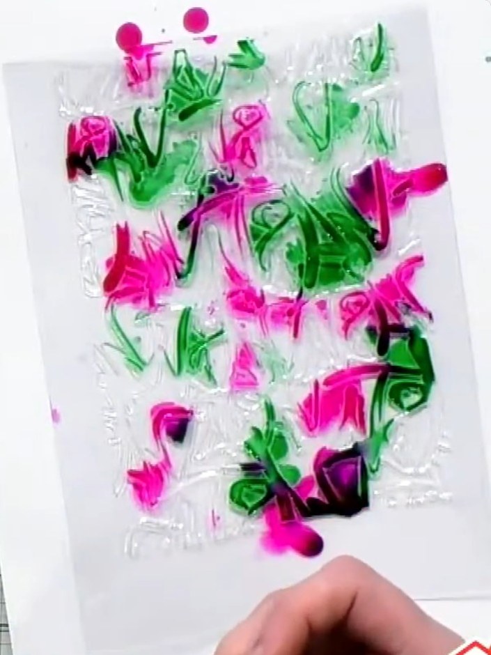 Step 3: Apply alcohol inks to the embossed acetate in green and magenta colours. Allow the inks to blend naturally on 