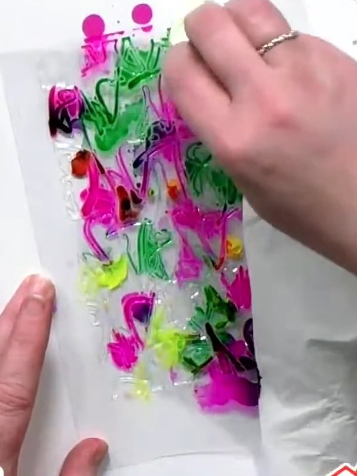 Step 4: If desired, add watercolour paint to the acetate, as it adheres well to the surface. Apply the paint in areas 