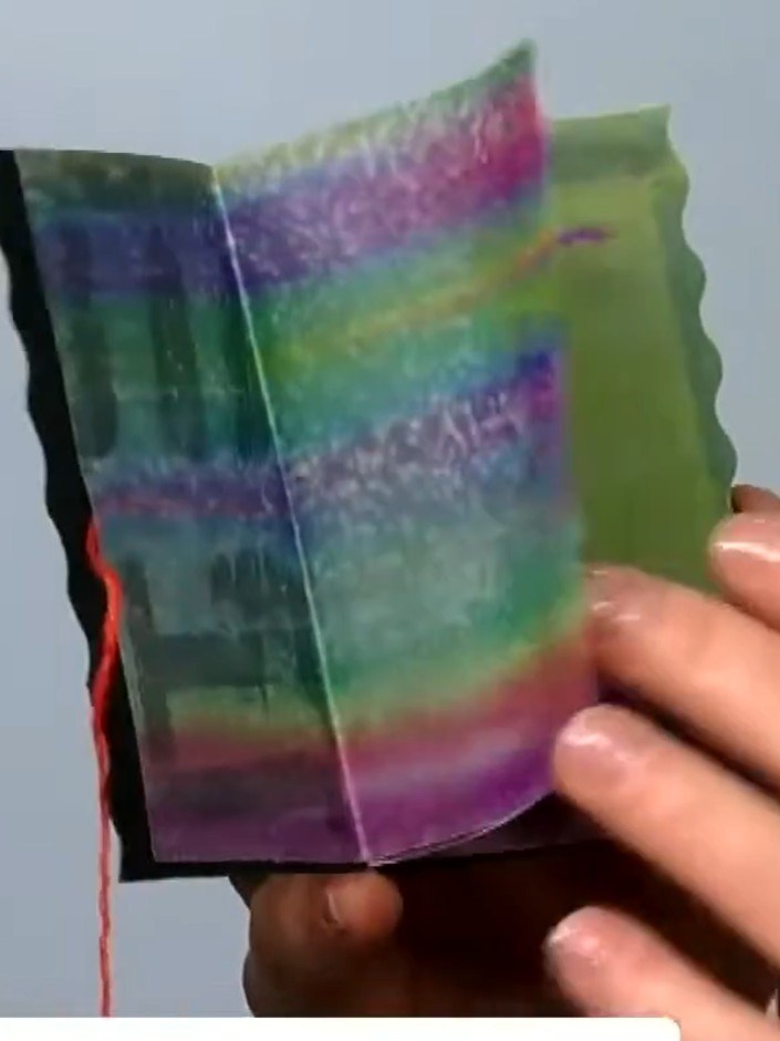 Step 4: Adhere the colourful collage paper borders to the edges of the vellum pages using minimal glue. Position the s