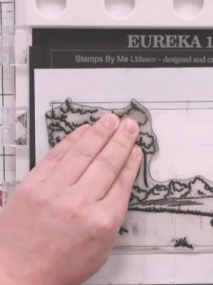 Step 3: Stamp the same dinosaur background image onto watercolour card cut to fit your centre panel, ensuring the stam