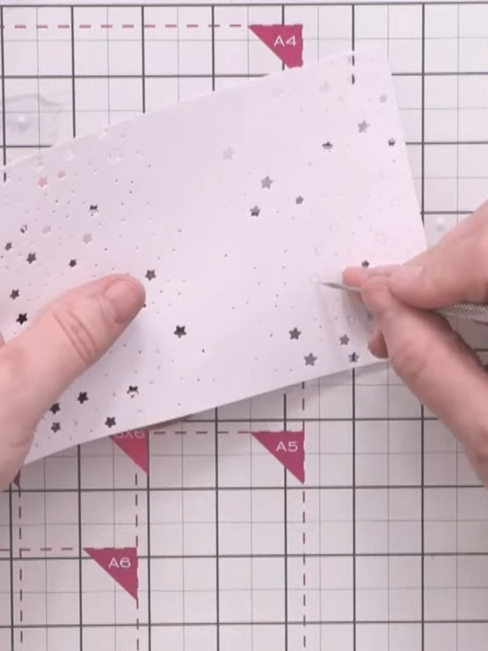 Step 2: Use the star and divot die to cut the top edge of your card, creating a decorative border with stars and small