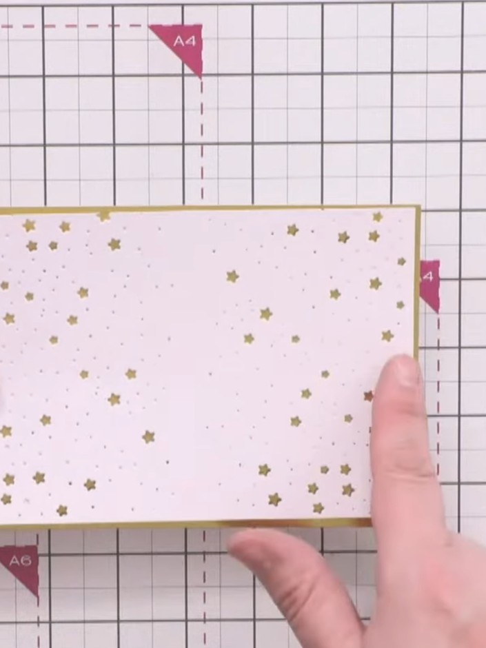 Step 4: Mount the die-cut card panel onto gold card, positioning the adhesive between the large stars so it doesn't sh