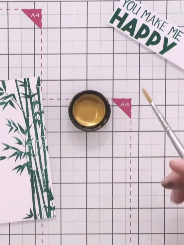 Step 7: Using a brush, apply pearl gold acrylic paint over the bamboo leaves to create an iridescent effect. Work sele