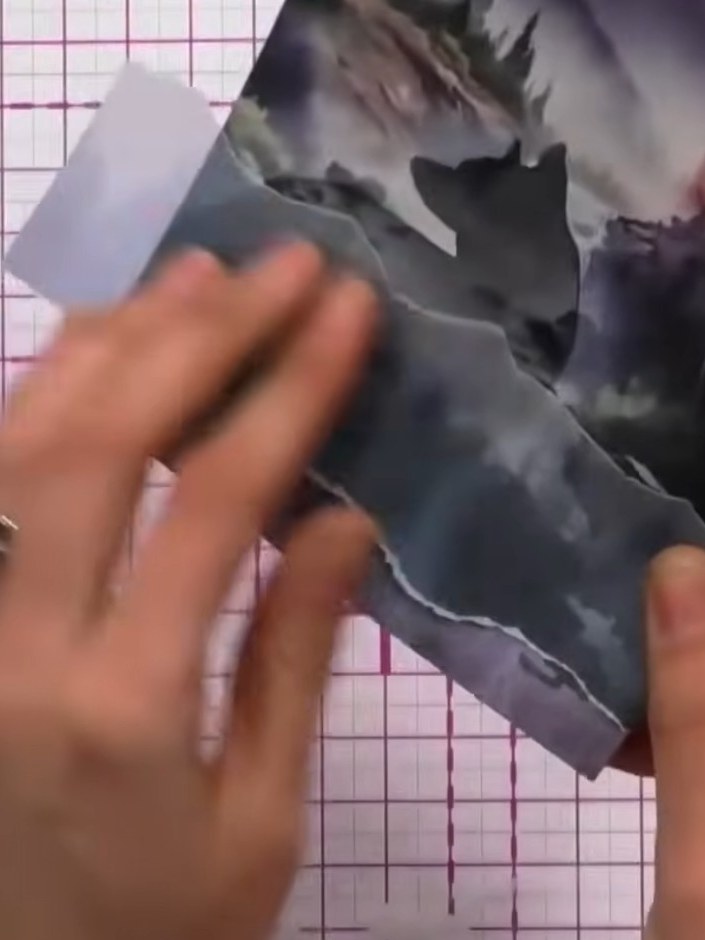 Step 2: Position the torn vellum piece across your stamped card front. Secure it in place with tape, pinning it down a