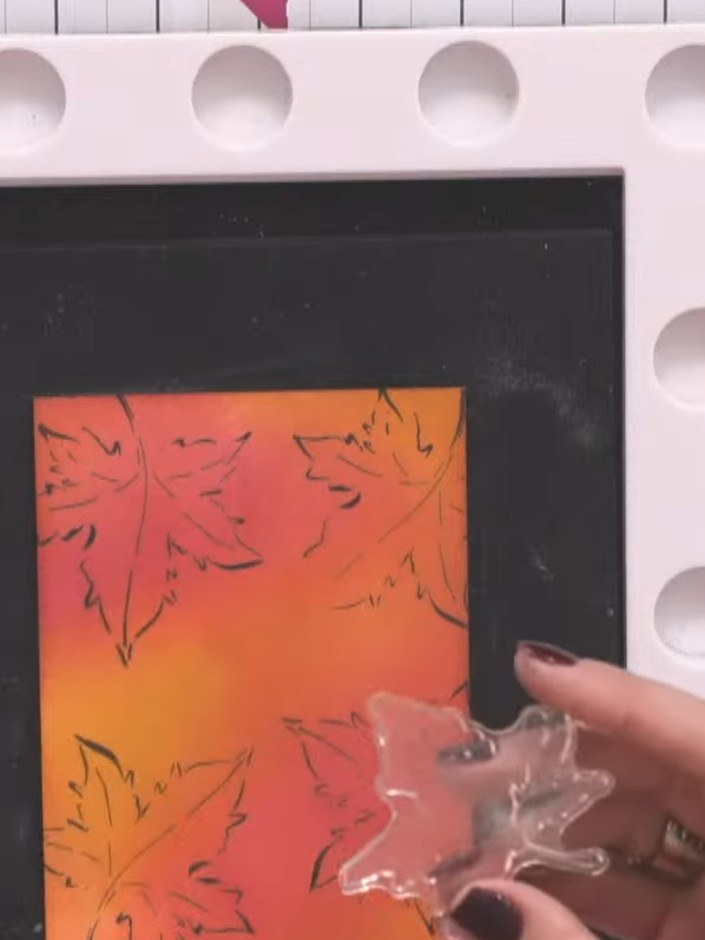 Step 4: Use a clear slow-drying embossing ink pad to stamp the solid leaf design over the blended coloured background.
