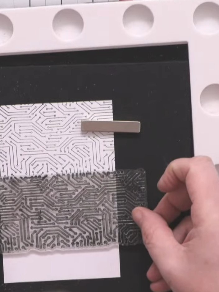 Step 2: Stamp two inner panels using the Cookie and Crash stamps, securing them with a magnetic mat to keep them stead