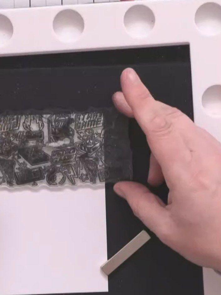 Step 3: Stamp the Game Over design onto two more black card panels using the Midnight ink. Align the stamp carefully o
