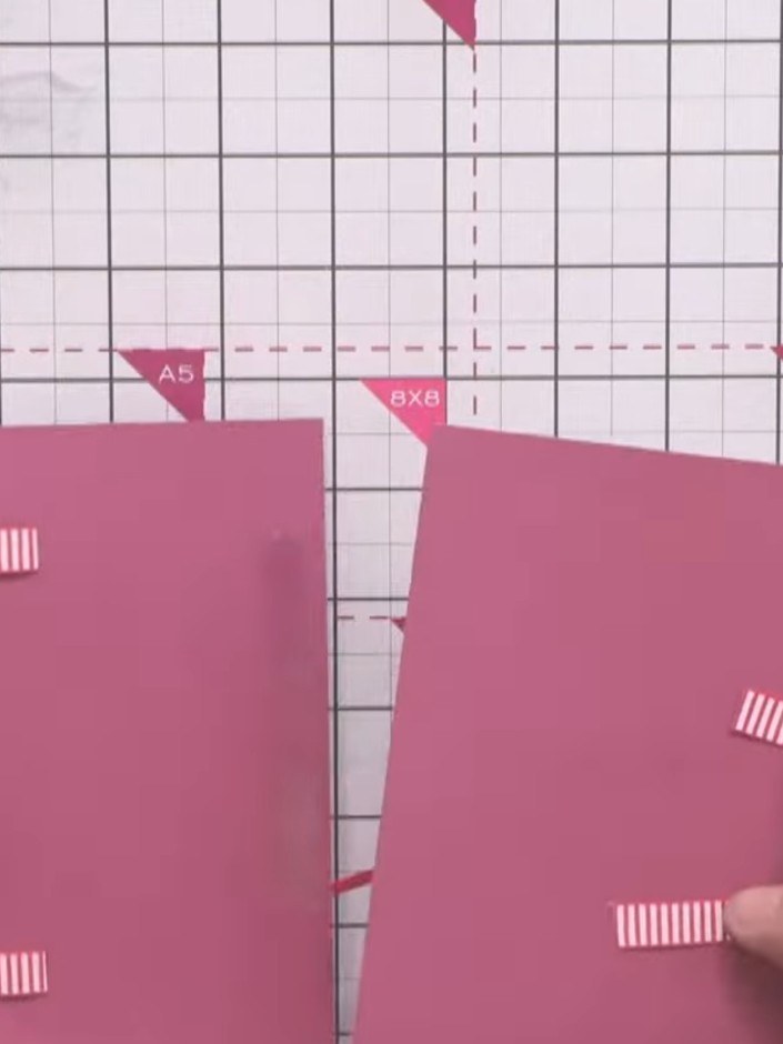 Step 8: Apply double-sided tape to the back of the two outer pink card panels. Position and adhere them over the ribbo