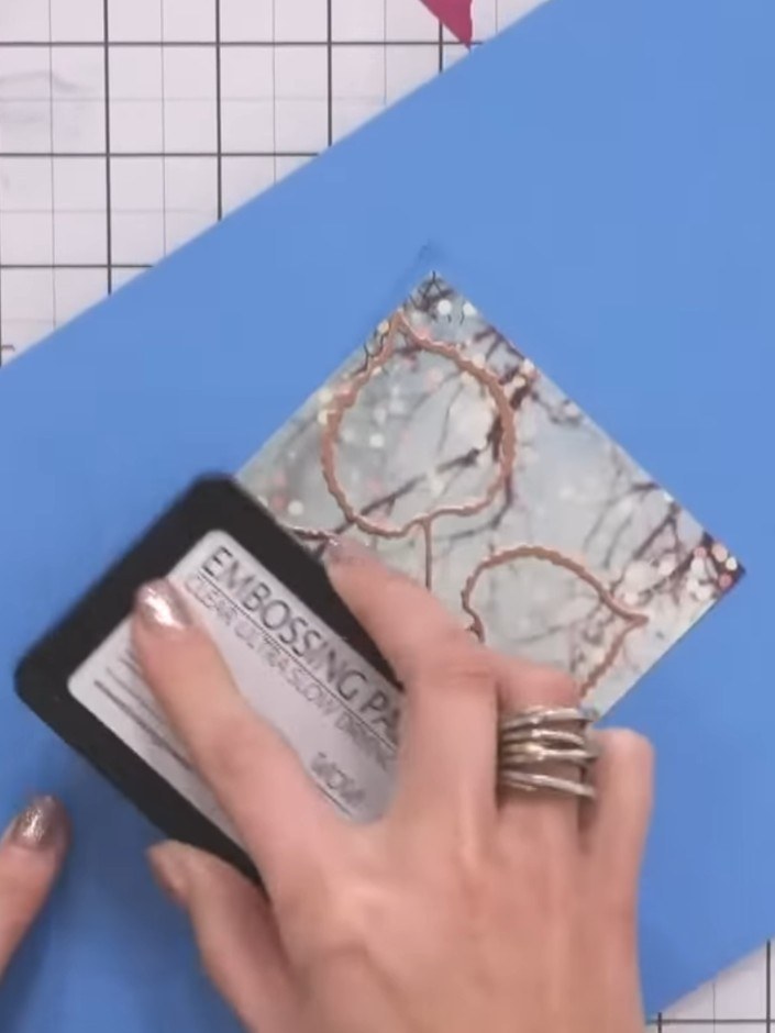 Step 5: Sprinkle Glitter Bug embossing powder generously over the stamped design, ensuring complete coverage of all th