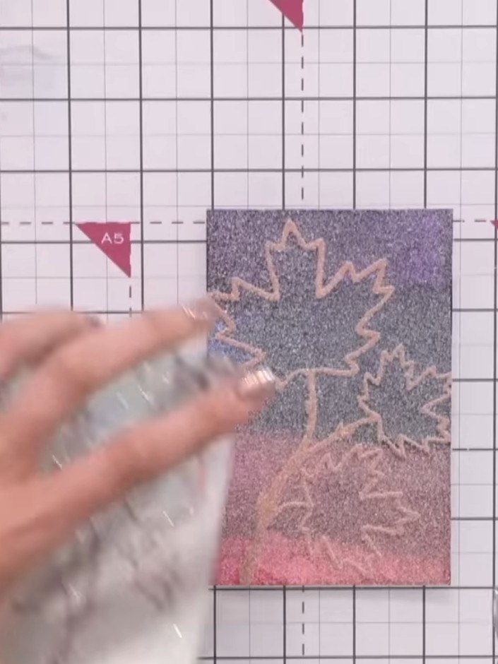 Step 7: Heat-set the embossing powder using a heat gun, moving it continuously over the design to avoid overheating. K