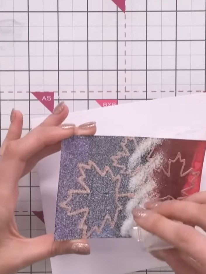 Step 11: Apply a second coat of sticky ink over the embossed design. Sprinkle ultra-thick clear embossing powder over t