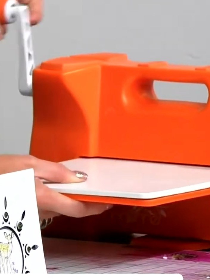 Step 2: Apply glue to the back of one white die-cut piece and adhere it flat onto the front of the white card base, po