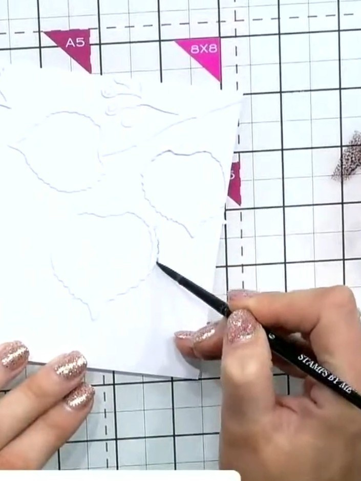 Step 5: Add a shadow effect by dabbing a grey or pale blue ink pad around the edges of the embossed design using a sma