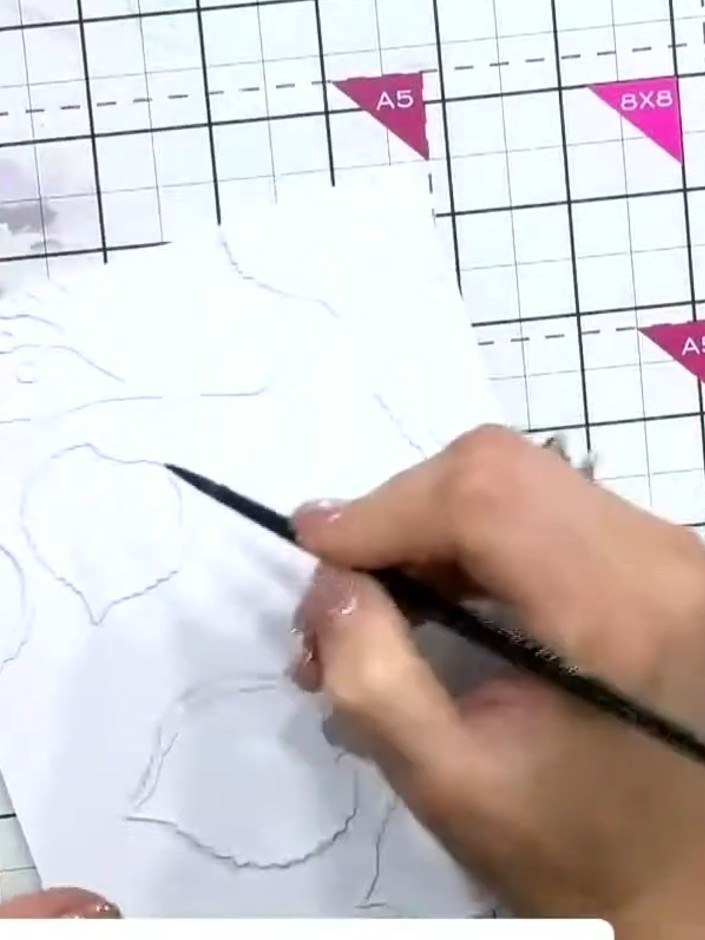 Step 6: Lightly water down the ink shadow with a damp brush to create a subtle cast shadow effect around the embossed 