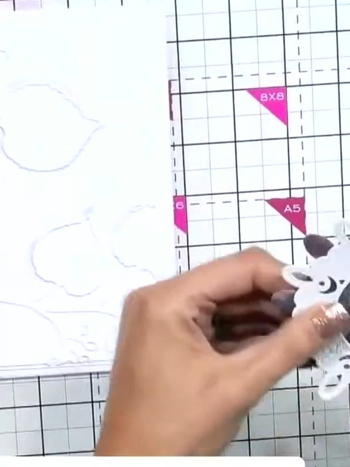 Step 7: Stamp a cute animal or sentiment from the A6 stamp set into the nested circle aperture. Position the stamp car